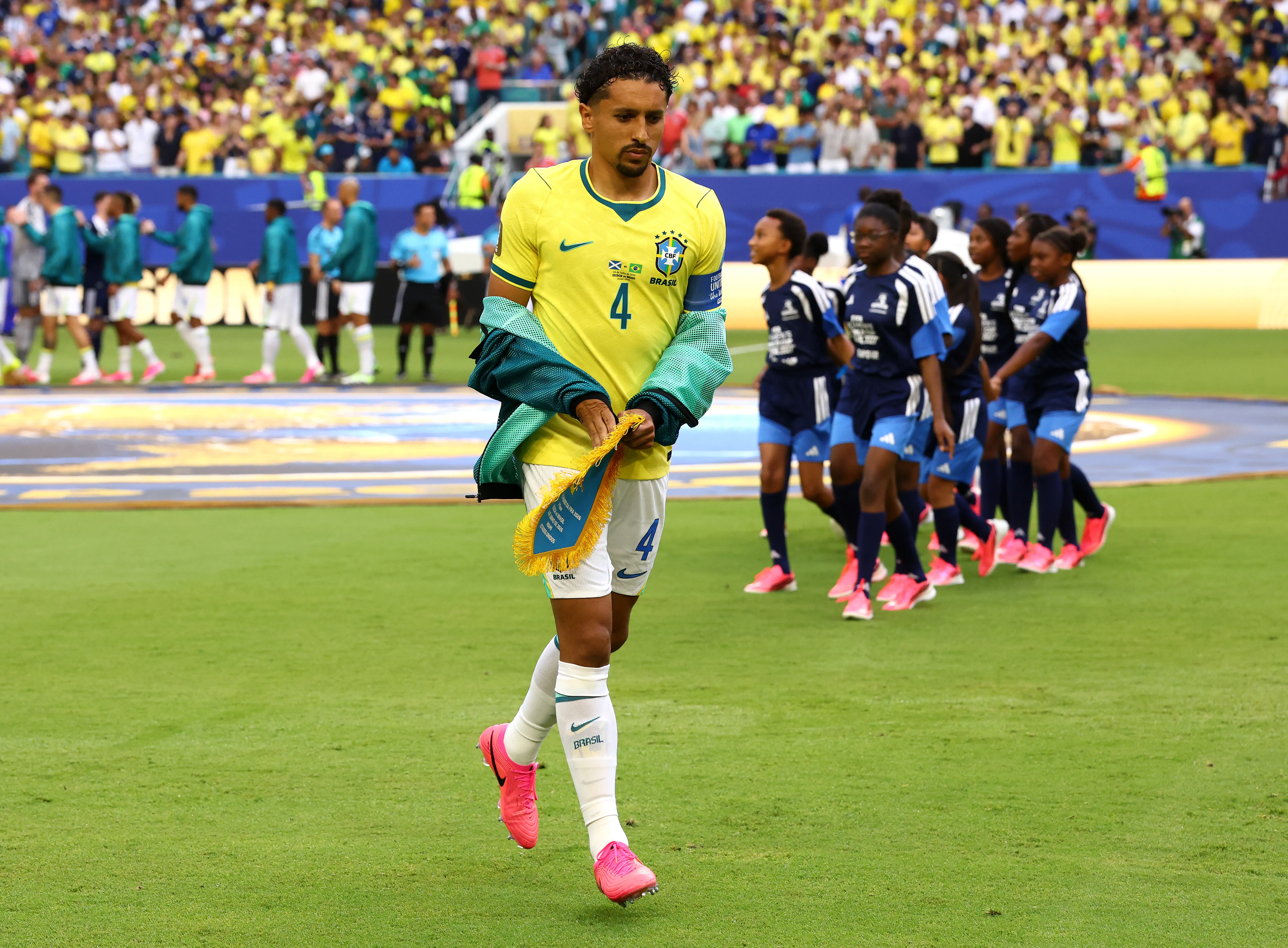 MIAMI GARDENS, FLORIDA – JUNE 24: Marquinhos #4 of Brazil holds the match pennant as he prepares for kick off before the FIFA World Cup 2026 Group C match between Scotland and Brazil at Miami Stadium on June 24, 2026 in Miami Gardens, Florida. (Photo by Robert Cianflone/Getty Images)