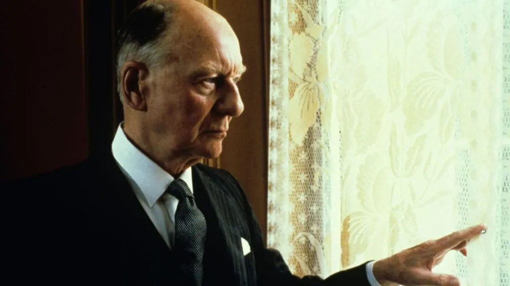 john gilegud looking through a window