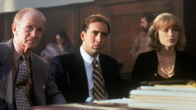Nicolas Cage, Bridget Fonda and Red Buttons in It Could Happen to You. (Source: IMDb)
