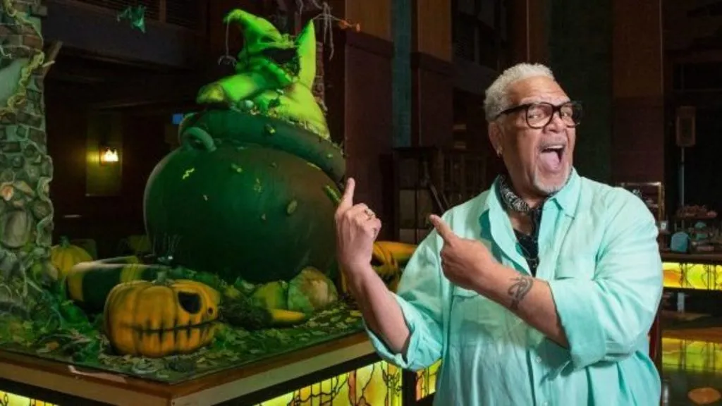 Ken Pages next to a statue of Oogie Boogie.
