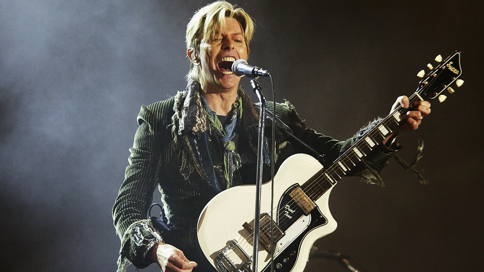 David Bowie performs on stage on the third and final day of “The Nokia Isle of Wight Festival 2004”. (Source: Jo Hale/Getty Images)