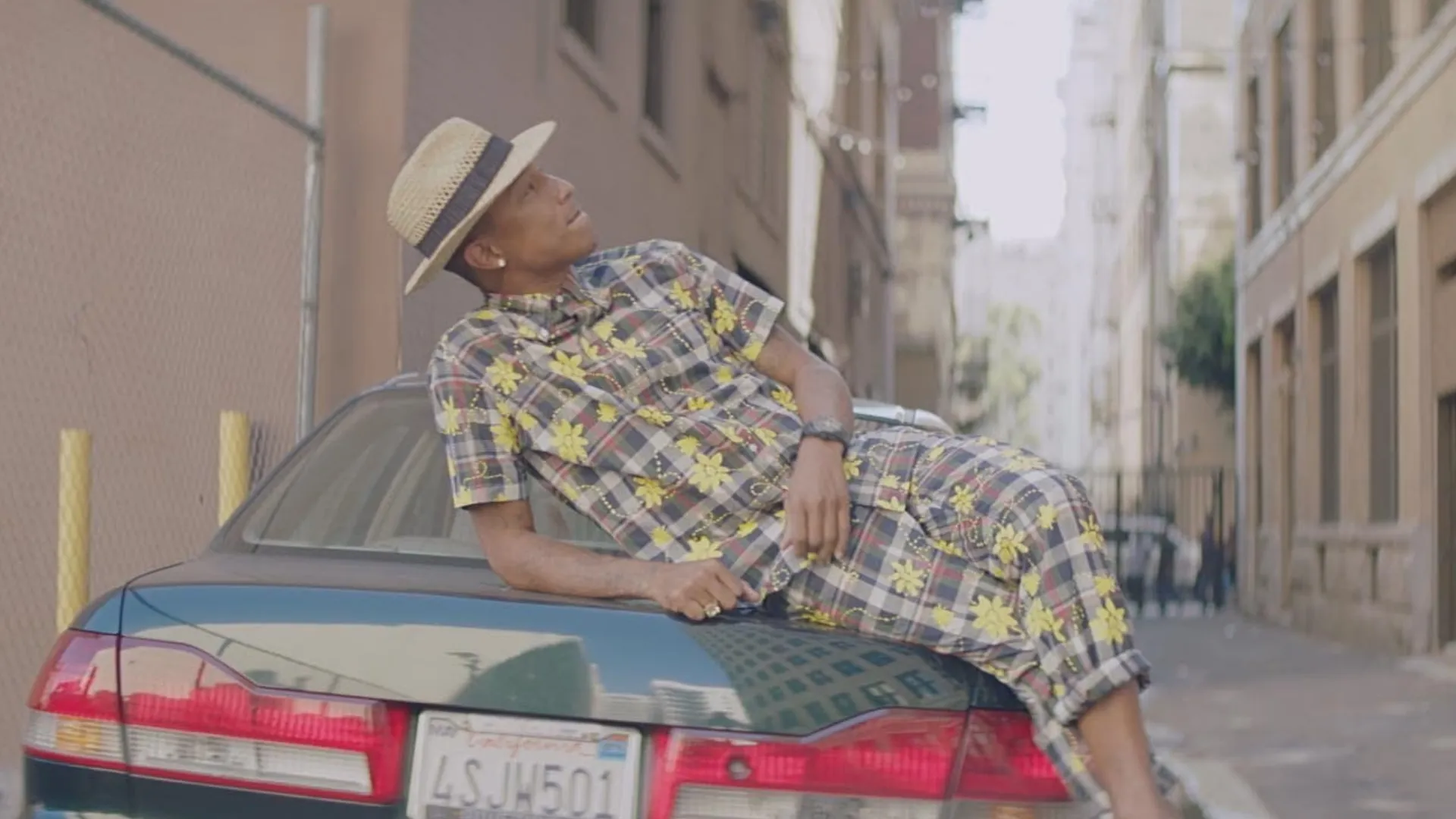 Pharrell Williams in the official video for Happy (Source: IMDb)