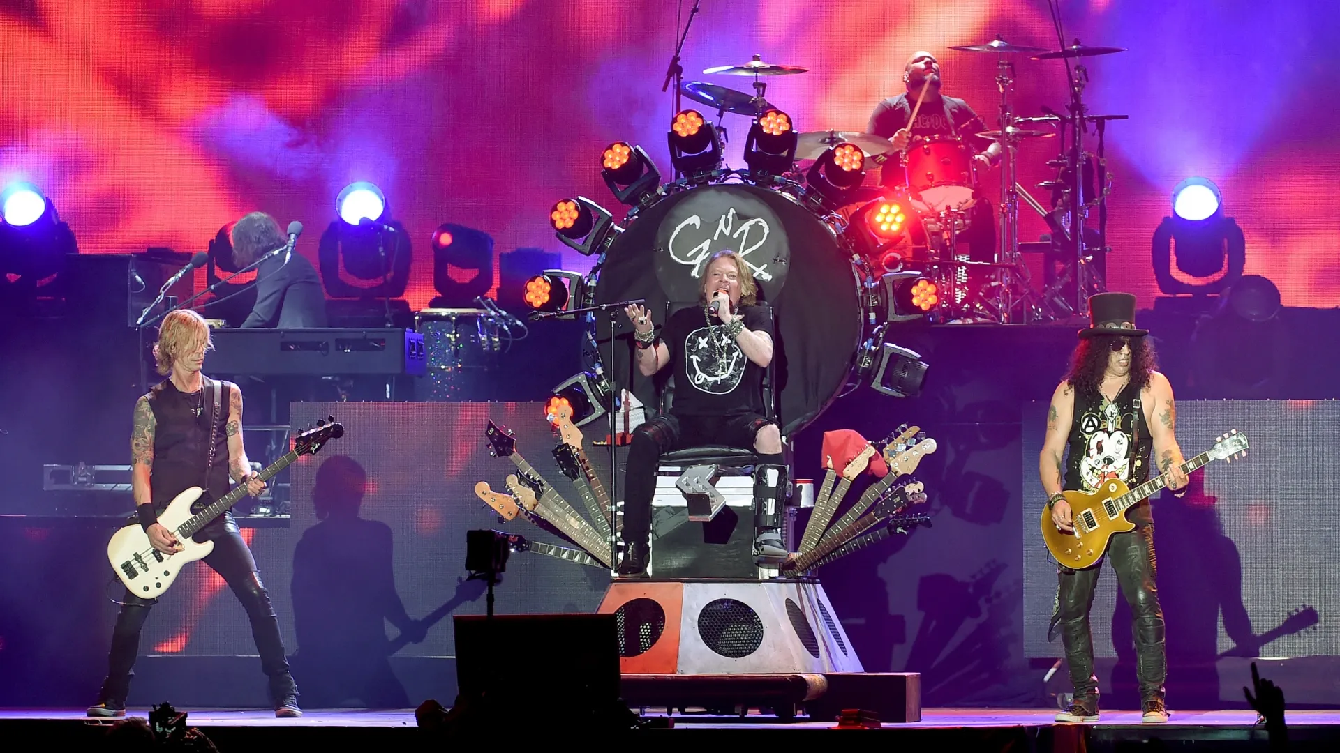 (L-R) Musician Duff McKagan, singer Axl Rose and musician Slash of Guns N’ Roses perform onstage during day 2 of the 2016 Coachella Valley Music &amp; Arts Festival Weekend 1 at the Empire Polo Club on April 16, 2016 in Indio, California. (Photo by Kevin Winter/Getty Images for Coachella)