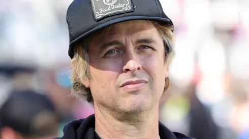 Billie Joe Armstrong of Green Day looks on from the field before Super Bowl LX.