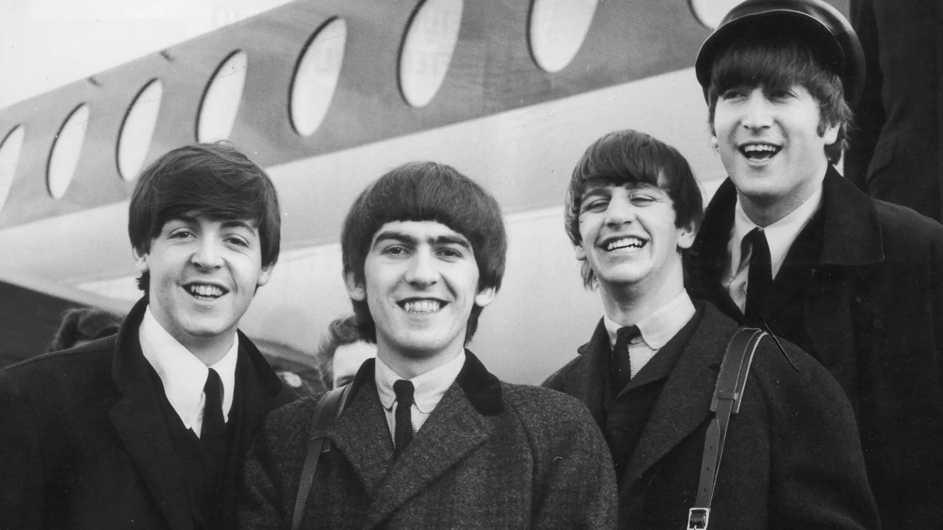 The Beatles, left to right, Paul McCartney, George Harrison, Ringo Starr and John Lennon (1940 – 1980) arrive at London Airport February 6, 1964, after a trip to Paris. Conflicting reports were released July 23, 2001 regarding Beatle George Harrison”s battle with cancer. Music producer Sir George Martin was quoted as saying that Harrison expects to die soon from his illnesses. The 58-year-old musician underwent treatment for a brain tumor at a clinic in Switzerland, and had surgery earlier this year for lung cancer. (Photo by Getty Images)
