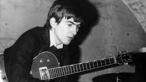 Beatle George Harrison with his guitar tucked under his arm takes a break from playing at the Cavern 1960 in Liverpool, England.