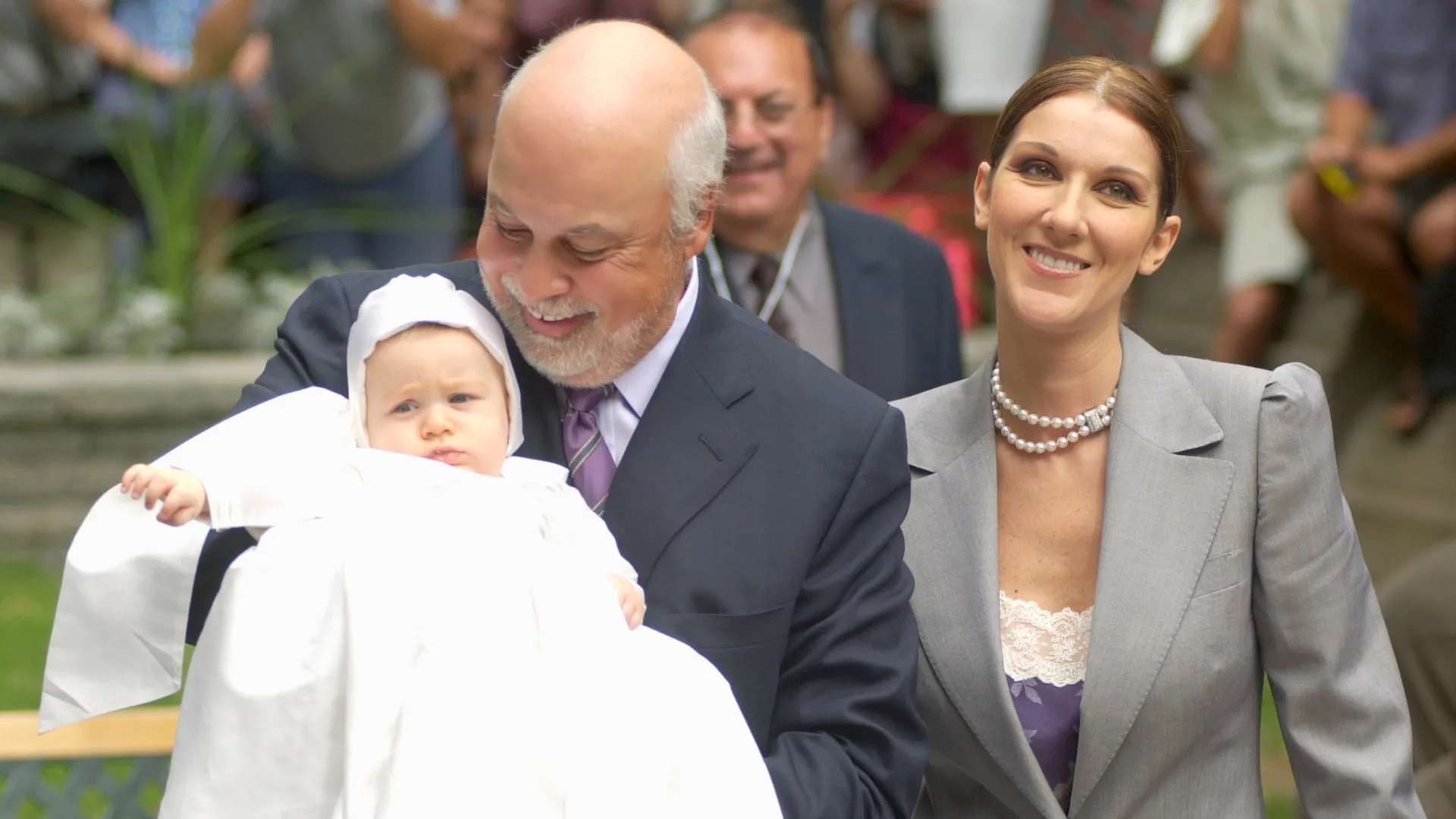 Celine Dion stands next to her husband, Rene Angelil, who holds their baby Rene-Charles in 2001 (Source: Pierre Roussel / Getty Images)