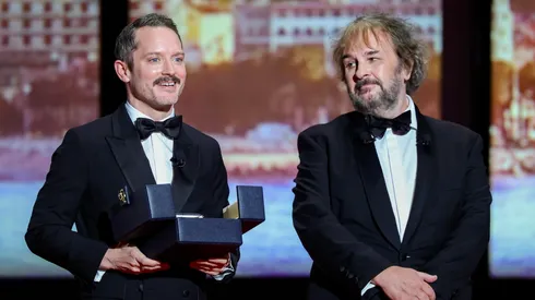 Peter Jackson (R) receives the Honorary Palme d'Or from Elijah Wood (L) on stage during the opening ceremony of the 79th annual Cannes Film Festival at Palais des Festivals.
