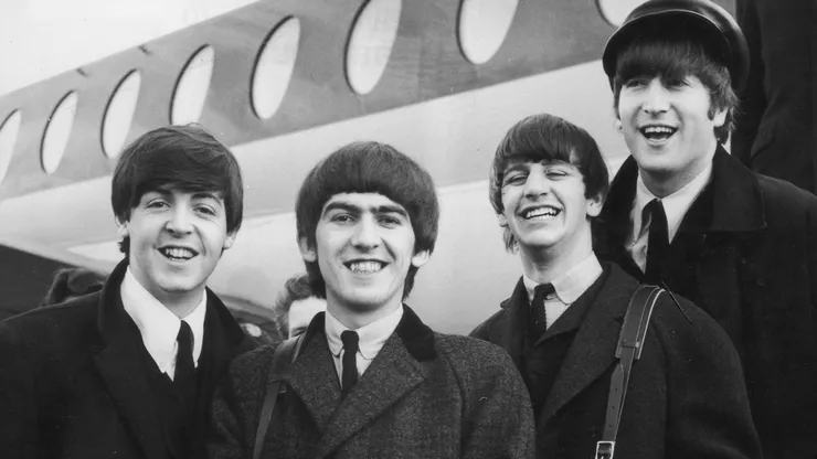 The Beatles, left to right, Paul McCartney, George Harrison, Ringo Starr and John Lennon (1940 - 1980) arrive at London Airport February 6, 1964, after a trip to Paris. Conflicting reports were released July 23, 2001 regarding Beatle George Harrison"s battle with cancer. Music producer Sir George Martin was quoted as saying that Harrison expects to die soon from his illnesses. The 58-year-old musician underwent treatment for a brain tumor at a clinic in Switzerland, and had surgery earlier this year for lung cancer.