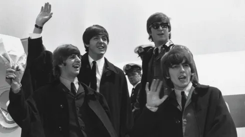 The Beatles (L to R) Ringo Starr, Paul McCartney, John Lennon and George Harrison wave to fans July 2, 1964 as they return to London from a tour of Australia.