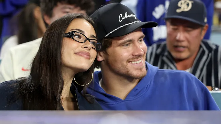 Singer and songwriter Madison Beer and Justin Herbert of the the Los Angeles Chargers watch game three of the 2025 World Series between the Toronto Blue Jays and the Los Angeles Dodgers at Dodger Stadium on October 27, 2025 in Los Angeles, California.